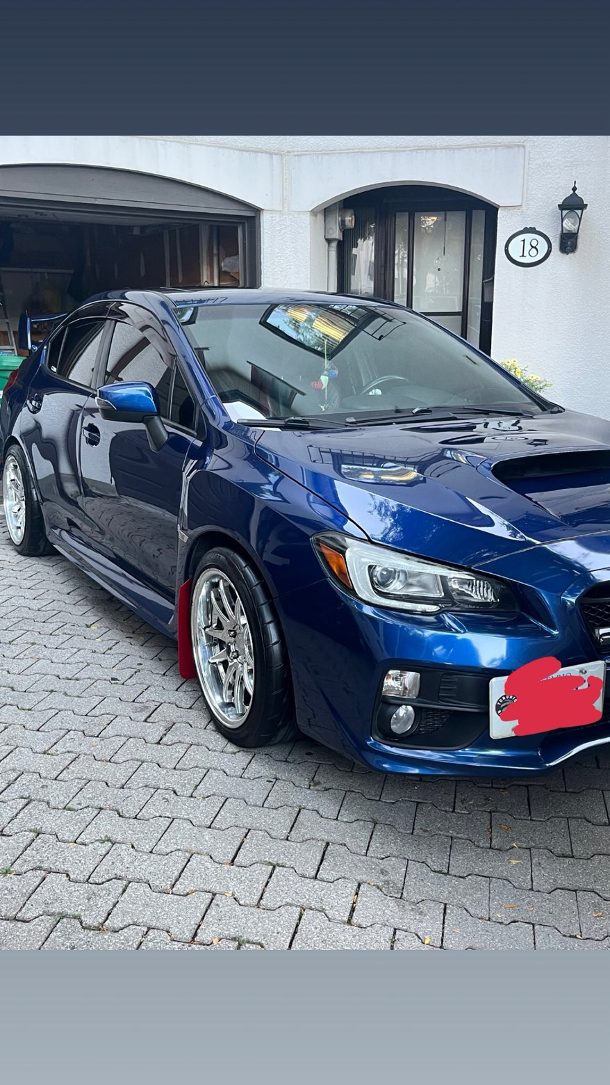 Blue Subaru WRX with a deep, glossy ceramic-coated finish