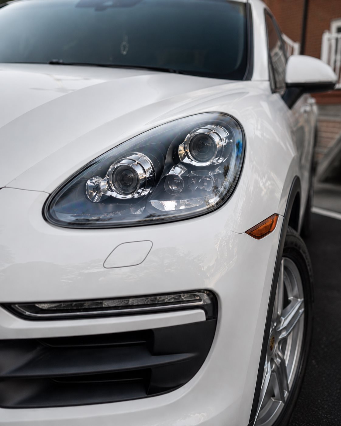 White Porsche Cayenne headlight, restored and spotless